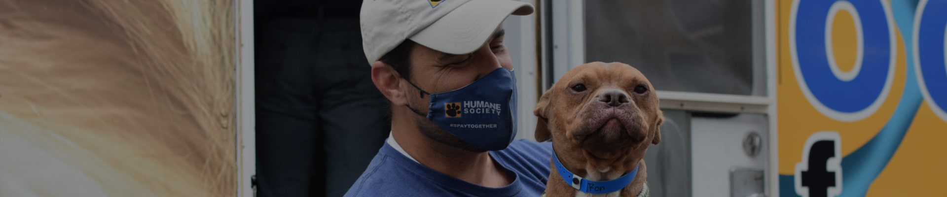 A man from the Humane Society holding a dog